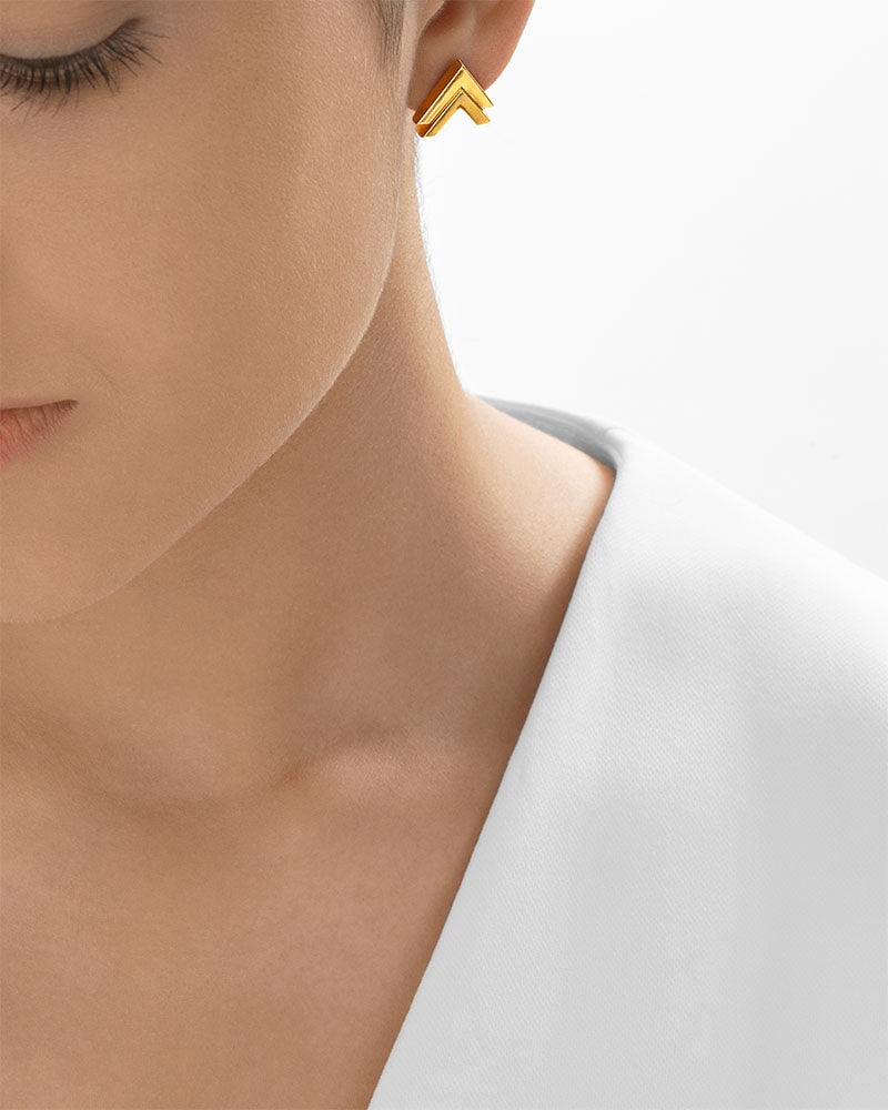 Double V gold stud earrings close-up